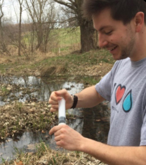 Spence Nash, Geauga SWCD Conservation Technician, taking a water sample
